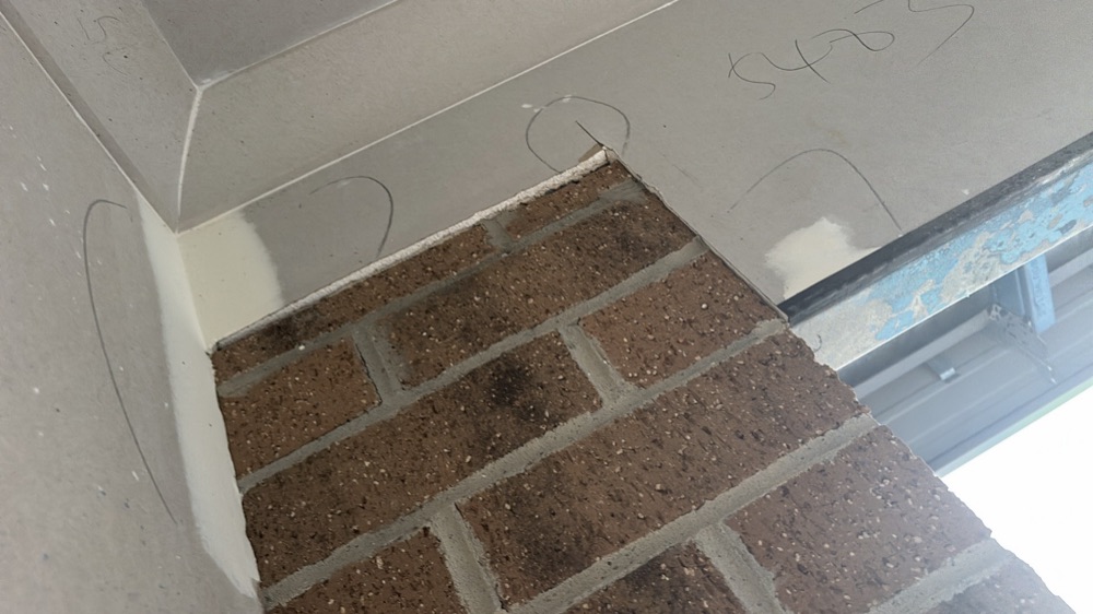 Plaster not flush at the garage wall, noted during a fixing inspection in Melton South