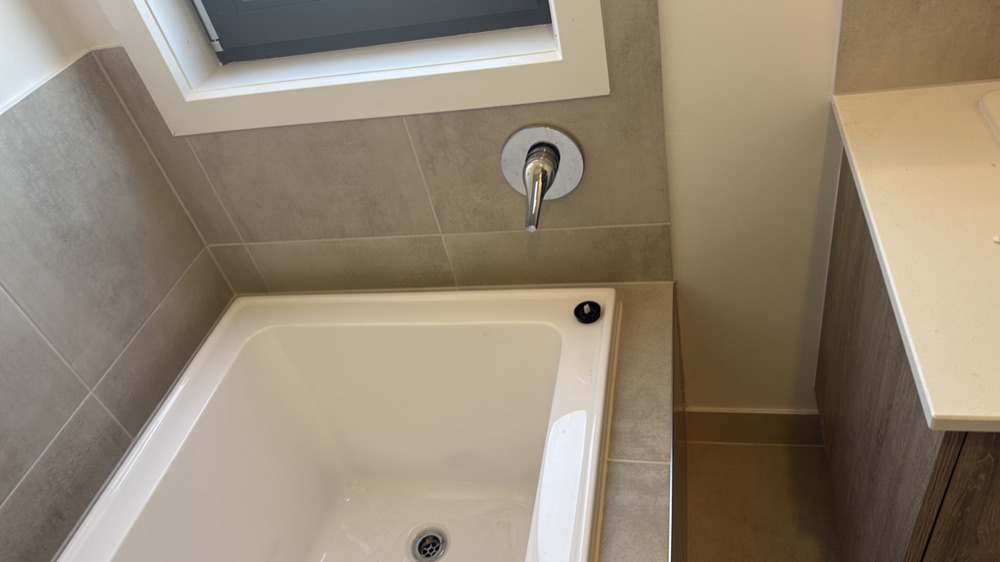 Water hammer heard when taps are operated, noted during a pre-handover inspection in Melton South